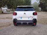 a small white car parked on the side of the road