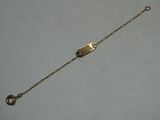 an image of a gold bracelet with a clasp on a white surface