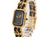 an image of a black and gold watch with a chain around it