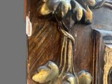 a close up of a clock on a wooden table