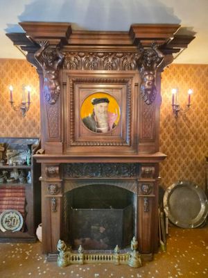 a picture of a fireplace in a room with a picture on the mantle