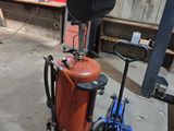 a fire extinguisor sitting on a cart in a garage