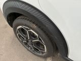 a close up of a tire on a white car