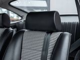 the back seats of a car with black and white checkered seats