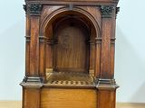 a small wooden clock sitting on top of a wooden table