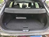 the back of a car with its trunk open and the seats folded down