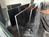 three computer monitors sitting on top of a table