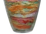 a glass vase that has a colorful design on it