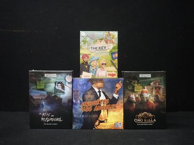 four dvds that are sitting on a black surface