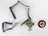 two medals and a pin on a white surface