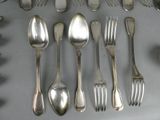 a lot of silver spoons and forks on the table