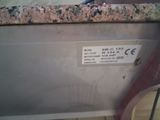 a label on the side of a machine that is sitting on a counter