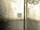 a close up of a metal door with a sticker on it