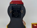 a clock that is sitting next to a box of keys