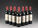 six bottles of red wine lined up in a row