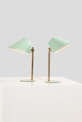 a pair of green lamps on a white table