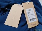 the back of a blue jacket with a price tag on it