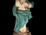a statue of a woman holding a basket in her hands