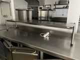 stainless steel counter top in a commercial kitchen with stainless steel appliances