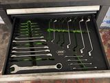 a tool drawer with tools in it in a garage
