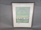 framed watercolor painting of a beach scene with rocks and waves