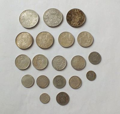a close up of a bunch of coins on a white surface