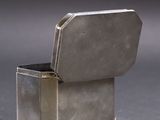 a small silver box with a lid on a table
