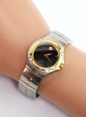 an image of a woman ' s wrist with a watch on it