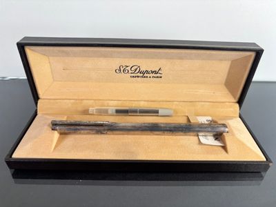 a pen in a box that is sitting on a table
