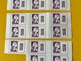 several stamps of different sizes and colors are on a yellow table