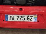 a red car that has a license plate on it