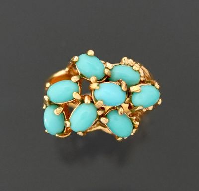 Bague en métal doré, ornée de cabochons de turquoise en sert…