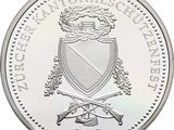an image of a silver coin with a coat of arms on it