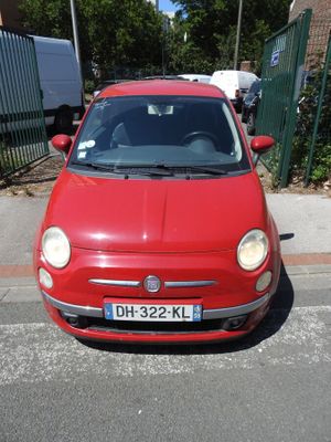a small red car parked on the side of the street