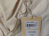 the label on the back of a white shirt is attached to the back of a white shirt