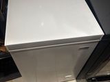 a white refrigerator sitting in a kitchen next to a stove