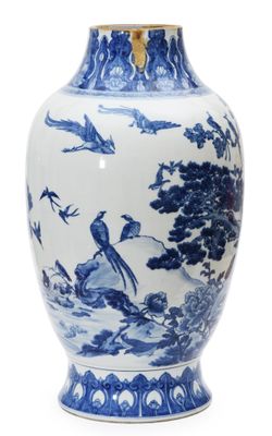 a blue and white vase with birds on it
