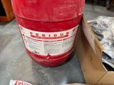 a large red barrel sitting on the floor next to a box of donuts