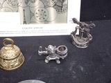 a picture of a collection of silver objects on a table