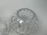 two glass vases that are sitting on a table