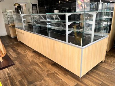 a glass display case with cars in it in a store