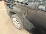 a car that has been painted black and is parked in a parking lot
