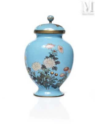 a blue vase with flowers painted on it on a white surface