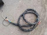a hose that is laying on the ground next to a tire
