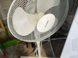 a white fan that is sitting on a stand