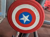 a captain america shield sitting on a stand in a gym