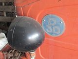 an old red truck with a number plate on it