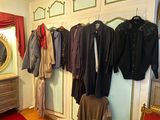 a lot of clothes hanging on the wall in this room