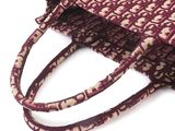 purple and beige woven bag with handles on a white background