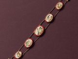 a red and white bracelet with a picture of a man and woman on it